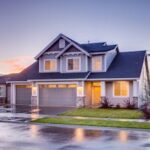 Elegant suburban home with driveway at sunset showcasing modern architecture.